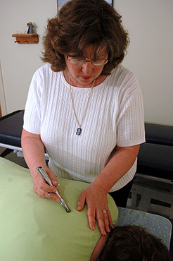 Dr. Ellie adjusting a patient.